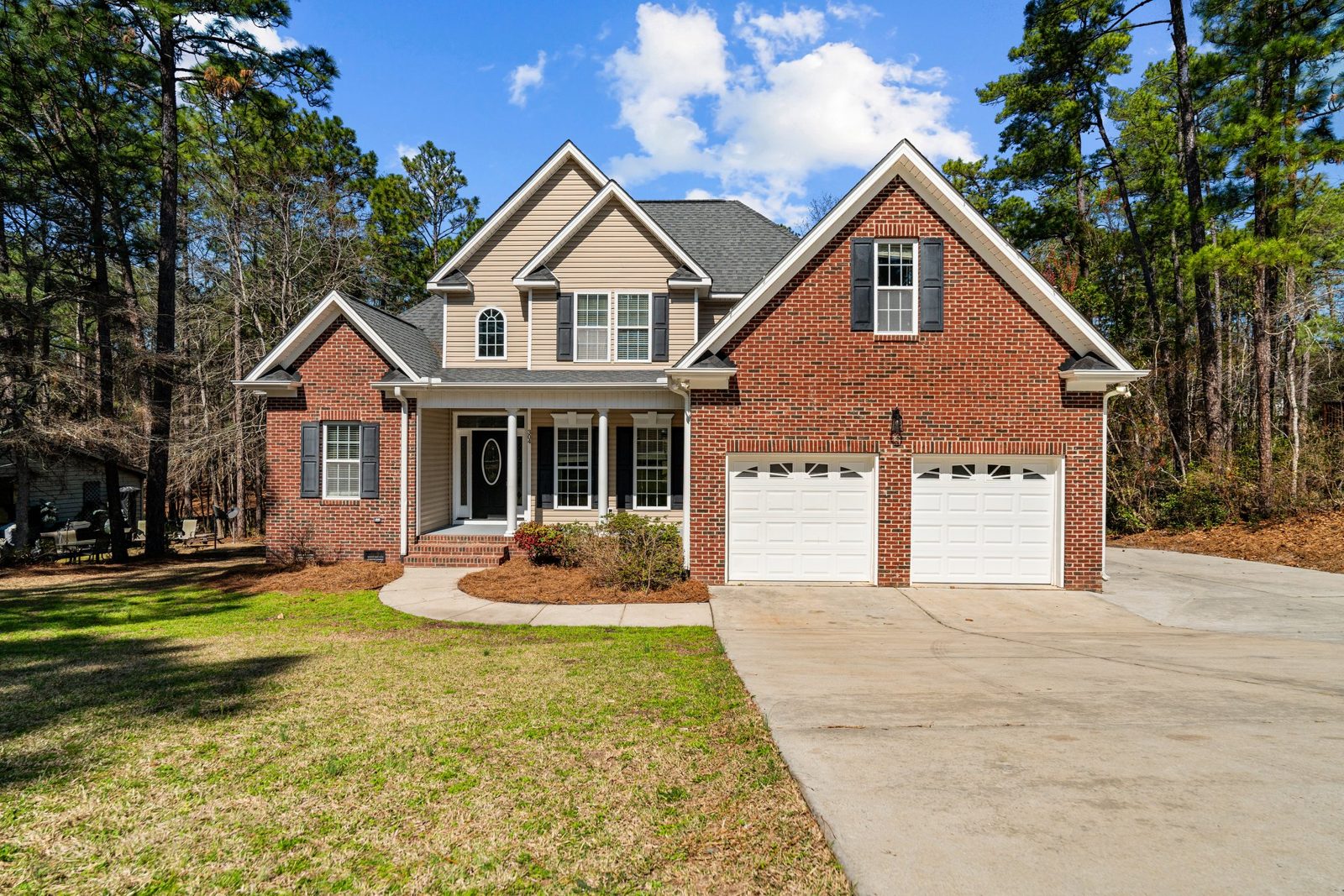 Brick and siding home with a new architectural shingle roof and two-car garage