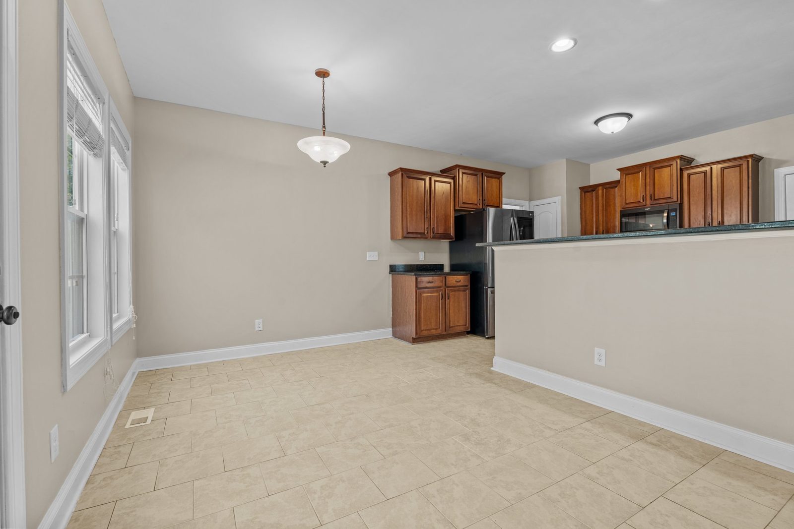 Kitchen and breakfast area with wood cabinets and pendant lighting