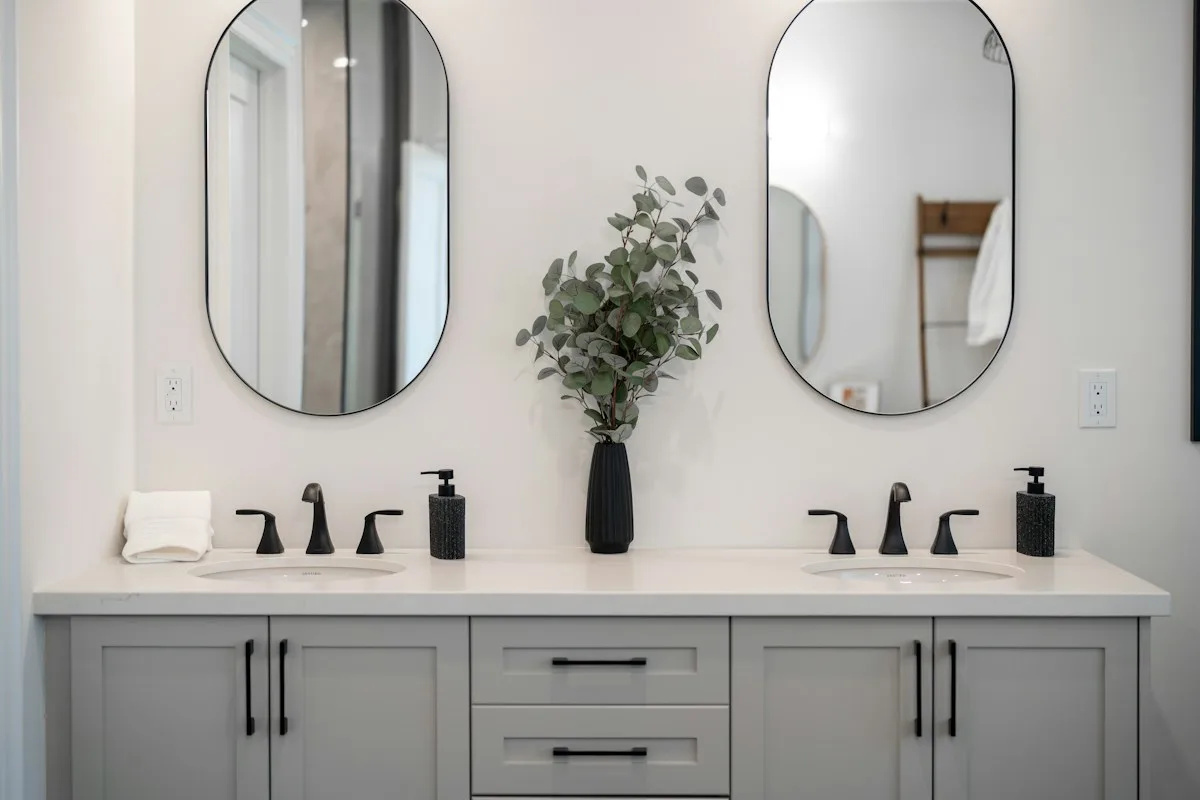 Gray double vanity with two sinks and oval mirrors